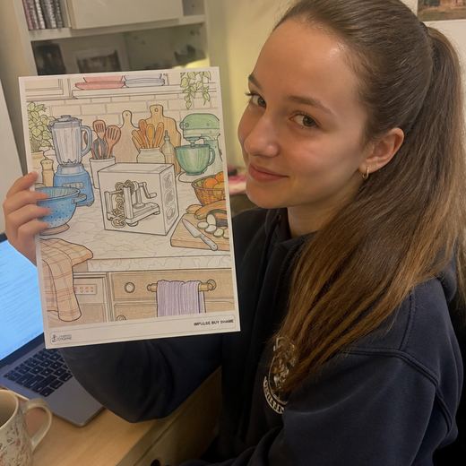 Real Journey Engine customer holding a page they hand-coloured