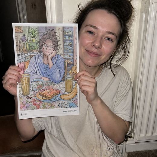 Real Journey Engine customer holding a page they hand-coloured