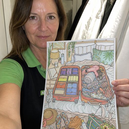 Real Journey Engine customer holding a page they hand-coloured
