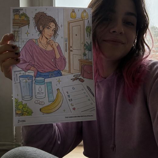 Real Journey Engine customer holding a page they hand-coloured