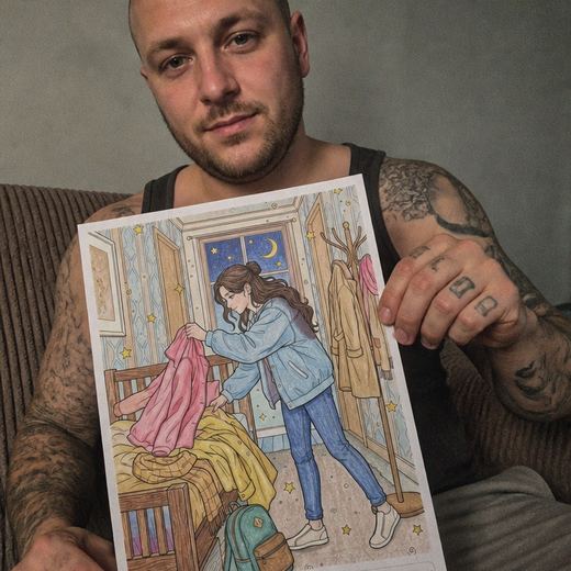 Real Journey Engine customer holding a page they hand-coloured