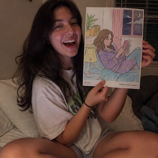 Real Journey Engine customer holding a page they hand-coloured
