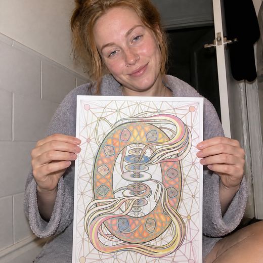Real Journey Engine customer holding a page they hand-coloured
