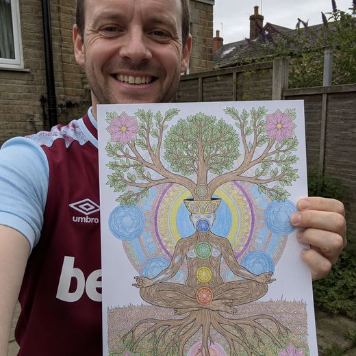 Real Journey Engine customer holding a page they hand-coloured