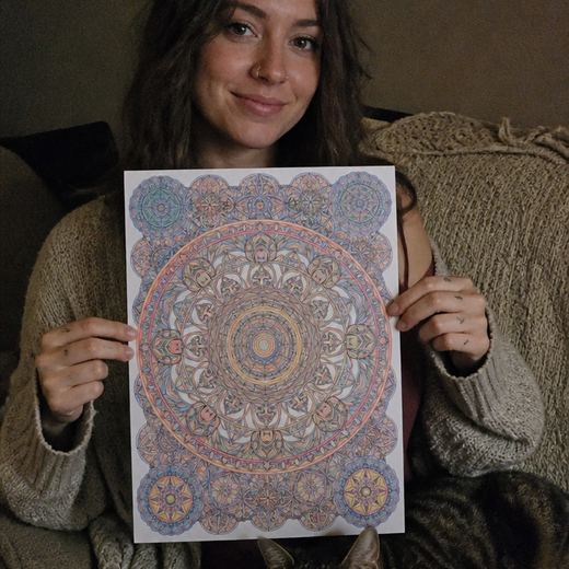 Real Journey Engine customer holding a page they hand-coloured