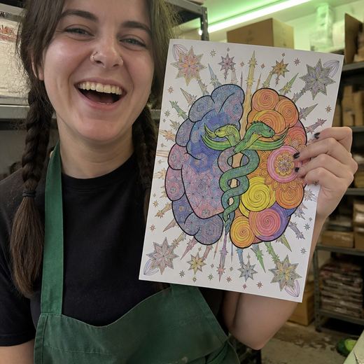 Real Journey Engine customer holding a page they hand-coloured