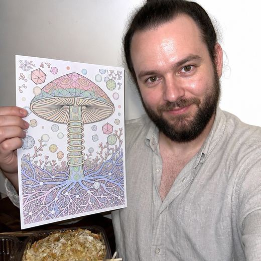 Real Journey Engine customer holding a page they hand-coloured